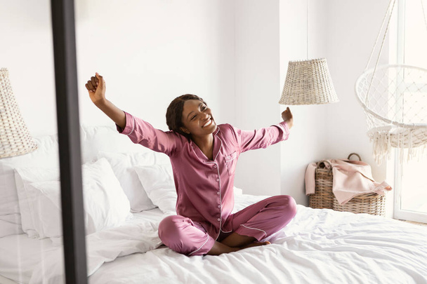Happy Well-Slept Black Female Stretching Hands After Sleep In Bedroom - Photo, Image