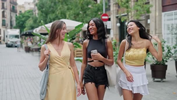 Drie mooie jonge modieuze vrouwen van verschillende rassen vrouwelijke beste vrienden hebben plezier in de stad - Video
