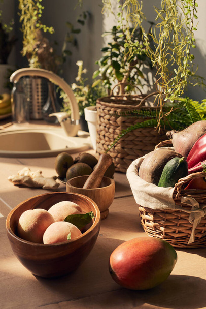 Still-life of fresh fruit and vegetables on kitchen table - Photo, image