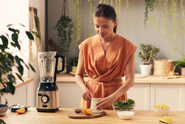 Young woman preparing ingredients for homemade smoothie - Photo, image