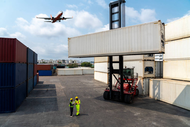 Industriële werknemer werkt samen met collega bij overzeese containerhaven - Foto, afbeelding