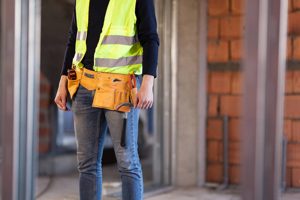 construction site worker wearing velt with tools - Fotoğraf, Görsel