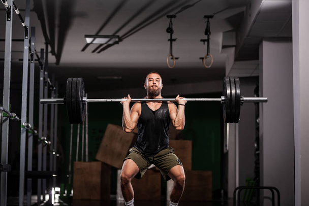 Muscular athlete lifting very heavy barbell.  - Valokuva, kuva