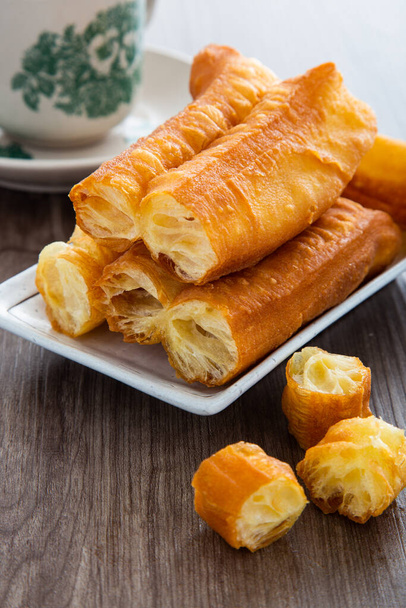 Youtiao (Chinese fried breadstick). Long golden brown deep fried dough strip. - Photo, Image