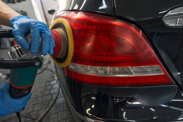 Auto detailing of car backlight on carwash service - Φωτογραφία, εικόνα