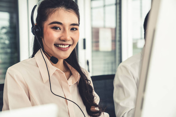Businesswoman wearing headset working actively in office - Foto, Imagen