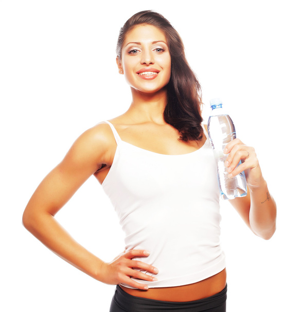 Smiling young sporty woman with water - Foto, imagen