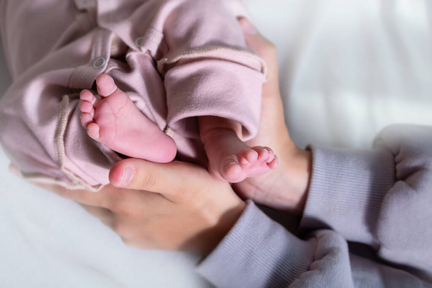 Newborn feets of caucasian newborn girl. Close-up. - Φωτογραφία, εικόνα