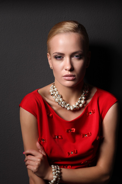 Young woman on red dress, isolated  black background - Фото, зображення