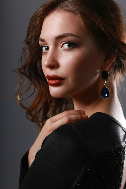 Portrait of beautiful brunette woman in black dress. - Фото, зображення