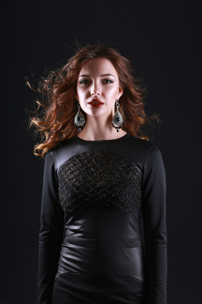 Portrait of beautiful brunette woman in black dress. - Fotó, kép