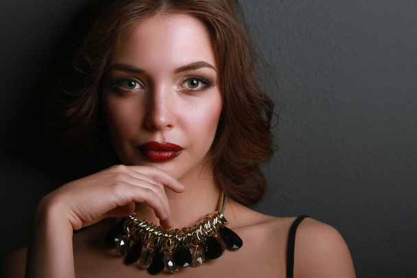 Portrait of young beautiful woman with jewelry - Fotografie, Obrázek