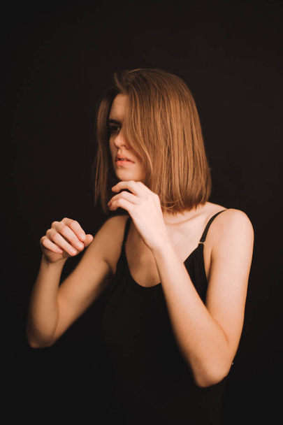 emotional portrait of a girl in the studio, a woman expresses difficult emotions on camera, a woman's mood in close-up. soft focus blurry and fuzzy background in portrait - Φωτογραφία, εικόνα