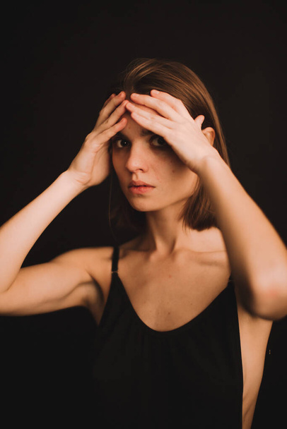 emotional portrait of a girl in the studio, a woman expresses difficult emotions on camera, a woman's mood in close-up. soft focus blurry and fuzzy background in portrait - 写真・画像