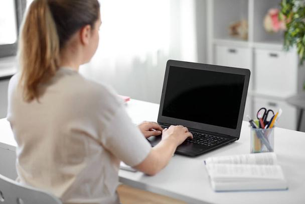 student woman with laptop and book at home - Foto, Imagem