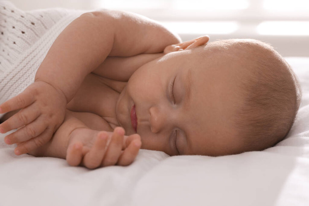 Cute little baby sleeping in bed, closeup - Фото, изображение