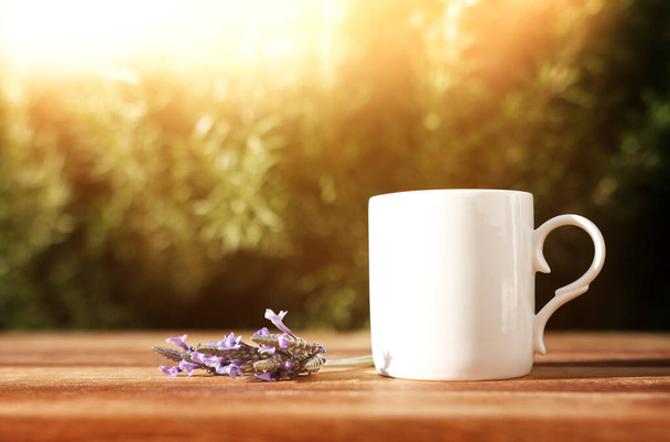 Tea cup on wooden table outdoors - Fotó, kép
