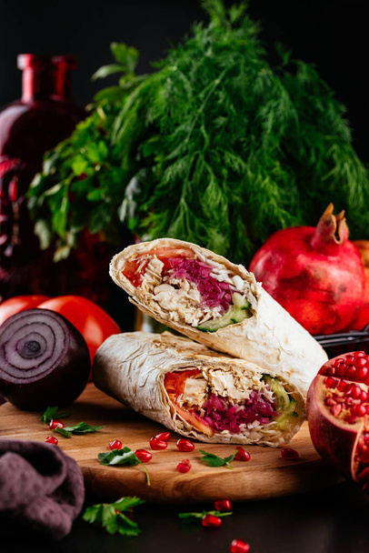 homemade shawarma with chicken, vegetables and cheese on a wooden background. selective focus - Photo, Image