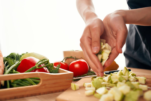 cutting vegetables on a cutting board kitchen cooking - Fotó, kép
