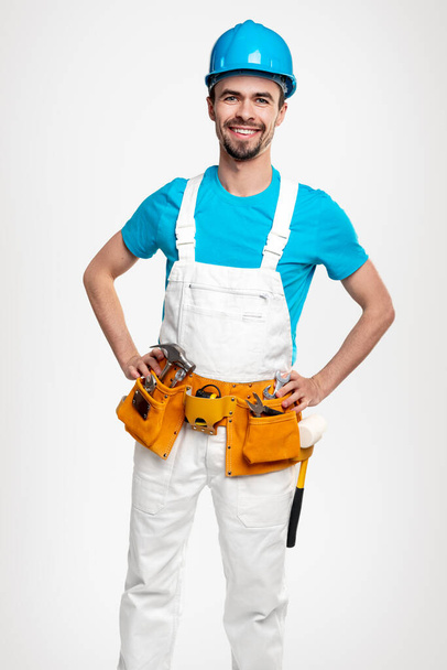Positive contractor in uniform with tools - Zdjęcie, obraz