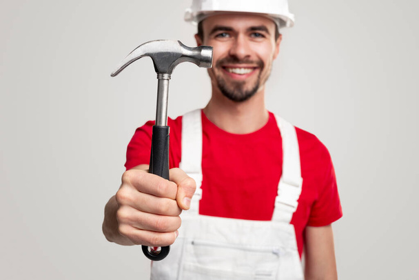 Smiling male builder with hammer - Fotoğraf, Görsel