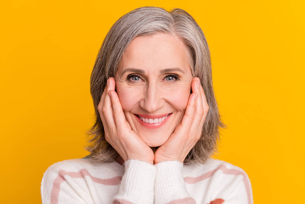 Photo of lovely white hairdo old lady hands face wear sweater isolated on yellow color background - Fotó, kép