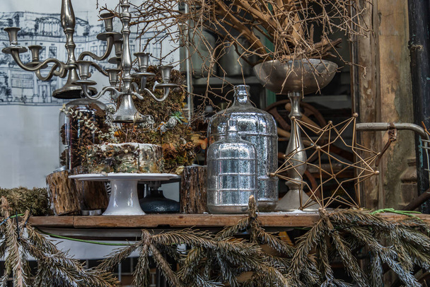 Antique candlestick and Dry plant, Dried flowers, Pine cones with Glass bottle Decorate on wooden table in cafe. Vintage shop decoration idea. Selective focus. - Valokuva, kuva