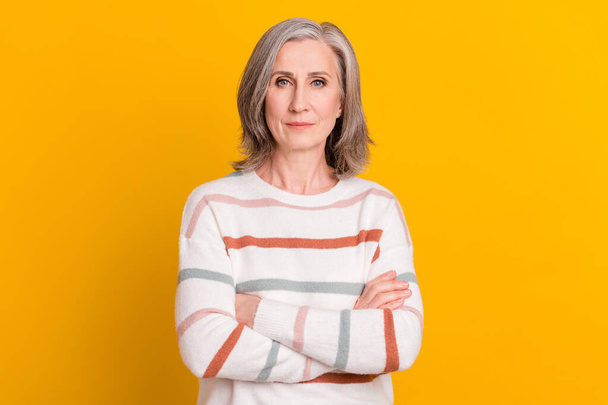 Portrait of attractive content serious grey-haired woman folded arms isolated over bright yellow color background - Фото, зображення