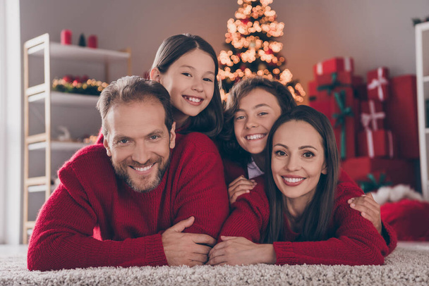 Photo of cheerful family have fun xmas atmosphere spirit winter decor parent kid lying floor indoors - Фото, зображення