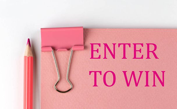 ENTER TO WIN word on the pink paper with pink pencil - Photo, Image