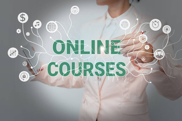 Text sign showing Online Courses. Business approach Revolutionizing formal education Learning through internet Lady In Uniform Standing And Holding Tablet Showing Futuristic Technology. - Photo, Image