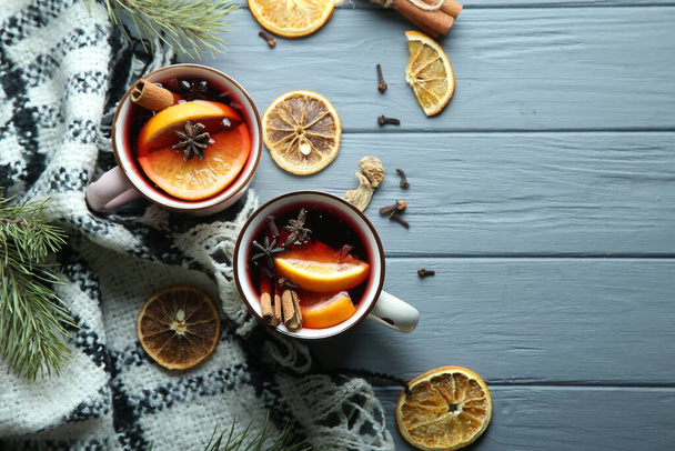 Hot winter cocktail, mulled wine on a wooden background. Top view, space for text. - Photo, Image