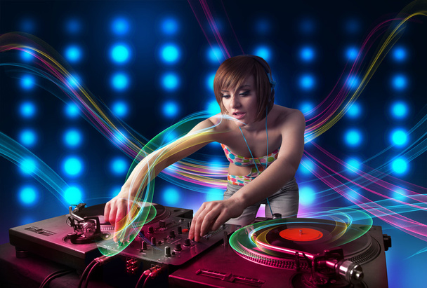Young Dj girl mixing records with colorful lights - Zdjęcie, obraz