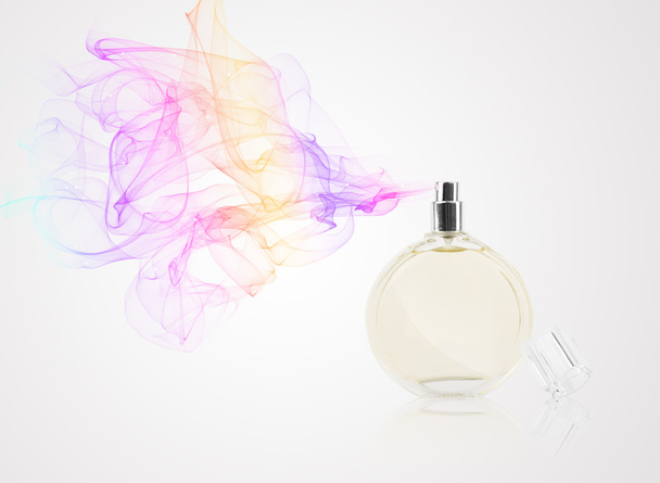 Perfume bottle spraying colored scent - 写真・画像