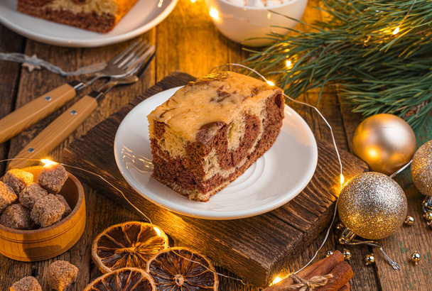Zebra cake with cocoa on a festive Christmas background. Side view, close-up - Photo, Image