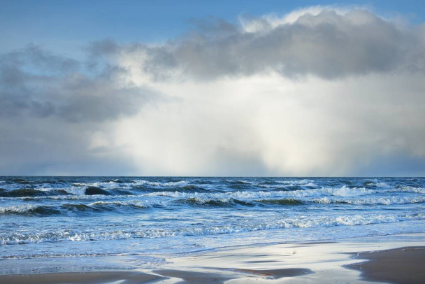 Panoramic view of Baltic sea from sandy shore (sand dunes). Dramatic sky with glowing clouds, sunbeams. Waves, water splashes. Idyllic seascape. Warm winter weather, climate change, nature. Denmark - Photo, Image