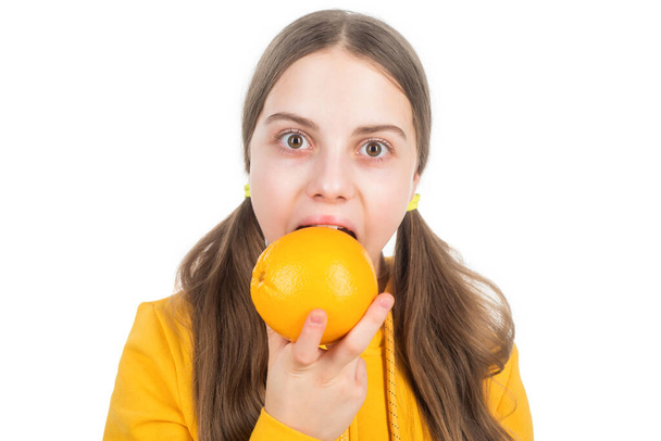 cheerful child eat citrus orange fruit full of vitamins isolated on white, eating - 写真・画像