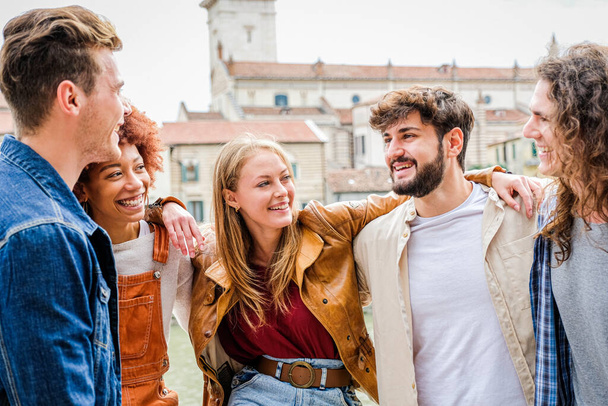 Group of friends happy  laughing together - Group of multiracial guys having fun on the city street - Portrait of five students from different culture celebrating outside - Friendship, community, youth, university concept - Photo, Image