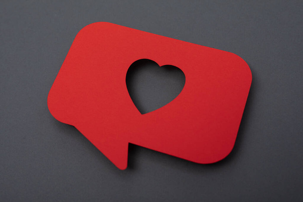 A red heart symbol on a grey background, valentine love - Foto, Imagem