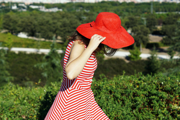 A Spanish woman wearing a red hat and posing - Φωτογραφία, εικόνα
