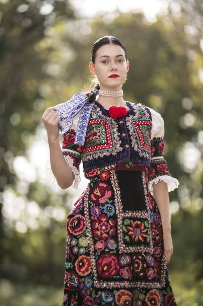Young beautiful slovak woman in traditional dress. Slovak folklore - Photo, Image