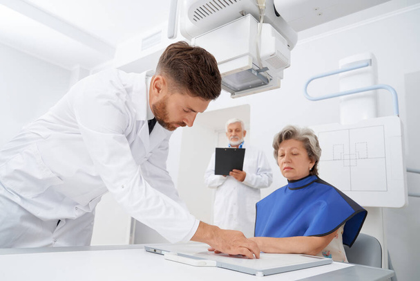 Radiologist put fingers of patient on scan for ultrasound. - Fotó, kép