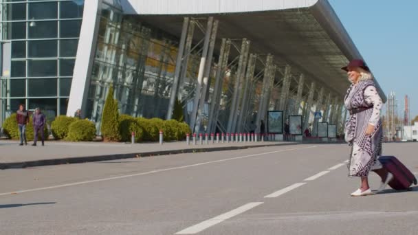 Starszy mąż i żona emerytów spotkanie turystów zjazd w terminalu lotniska po podróży - Materiał filmowy, wideo