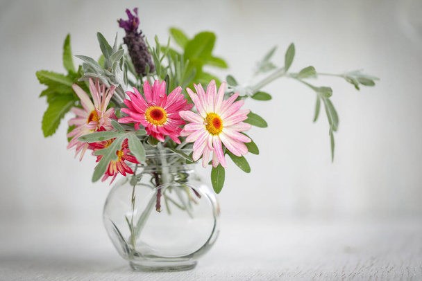 Collection of fresh flowers picked from cottage garden in small vase on white background - Fotoğraf, Görsel