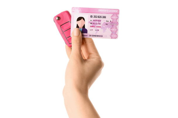 Woman with driving license and car key on white background - Photo, Image
