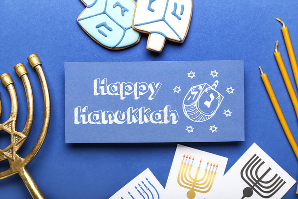 Different symbols of Hanukkah and greeting card on color background - Fotografie, Obrázek