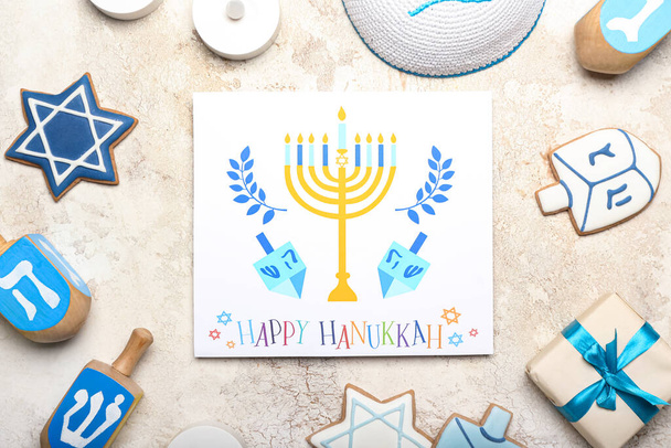 Different symbols of Hanukkah and greeting card on grunge background - Foto, afbeelding