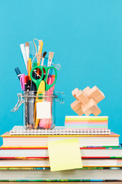 School accessories on desktop with plain blue background - Foto, imagen