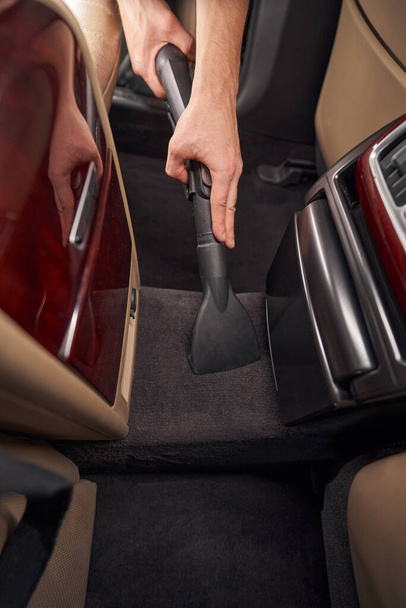 Photo of cleaning and vacuuming car interior during car detailing - Valokuva, kuva