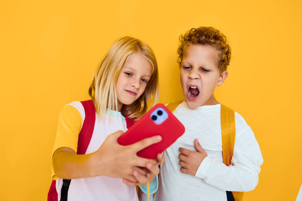 Fotografie dvou malých dětí dívka telefon selfie grimace zábava Studio vzdělávání koncept - Fotografie, Obrázek